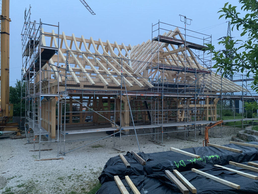 Aussenansicht der Fachwerkhalle mit offenen Holzträgern
